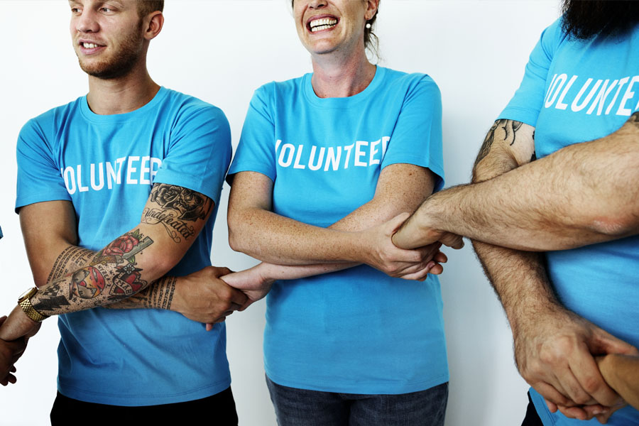 Non-Profit Insurance - Volunteers Holding Hands and Embracing